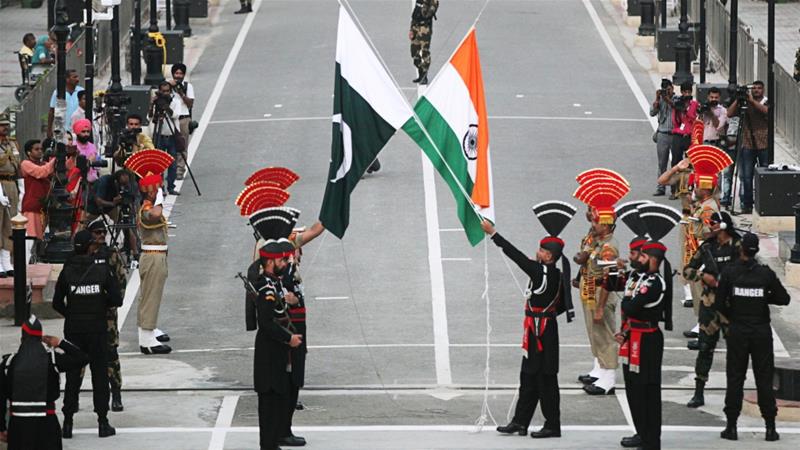 Retreat ceremony at the India-Pakistan boarder with two flags crossed overhead
