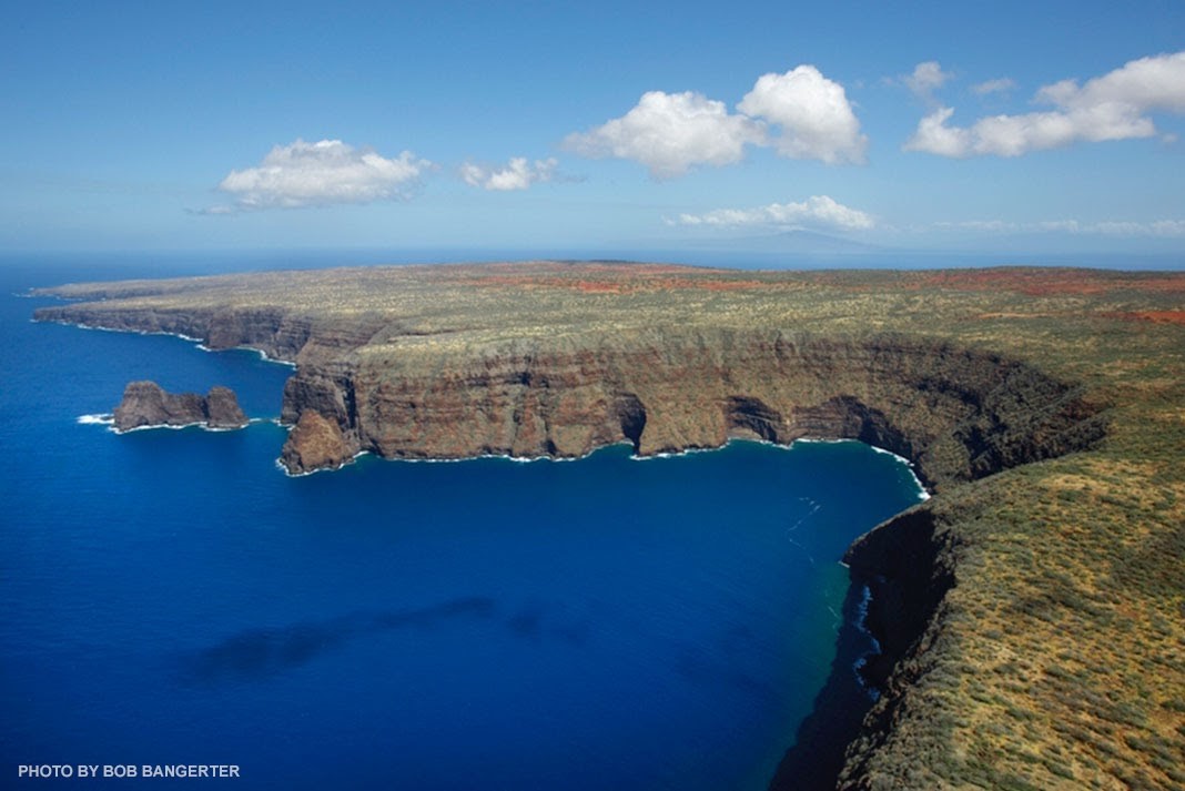 the shore of the island of Kaho'olawe surrounded by blue sky and dark blue sea on 3 sides
