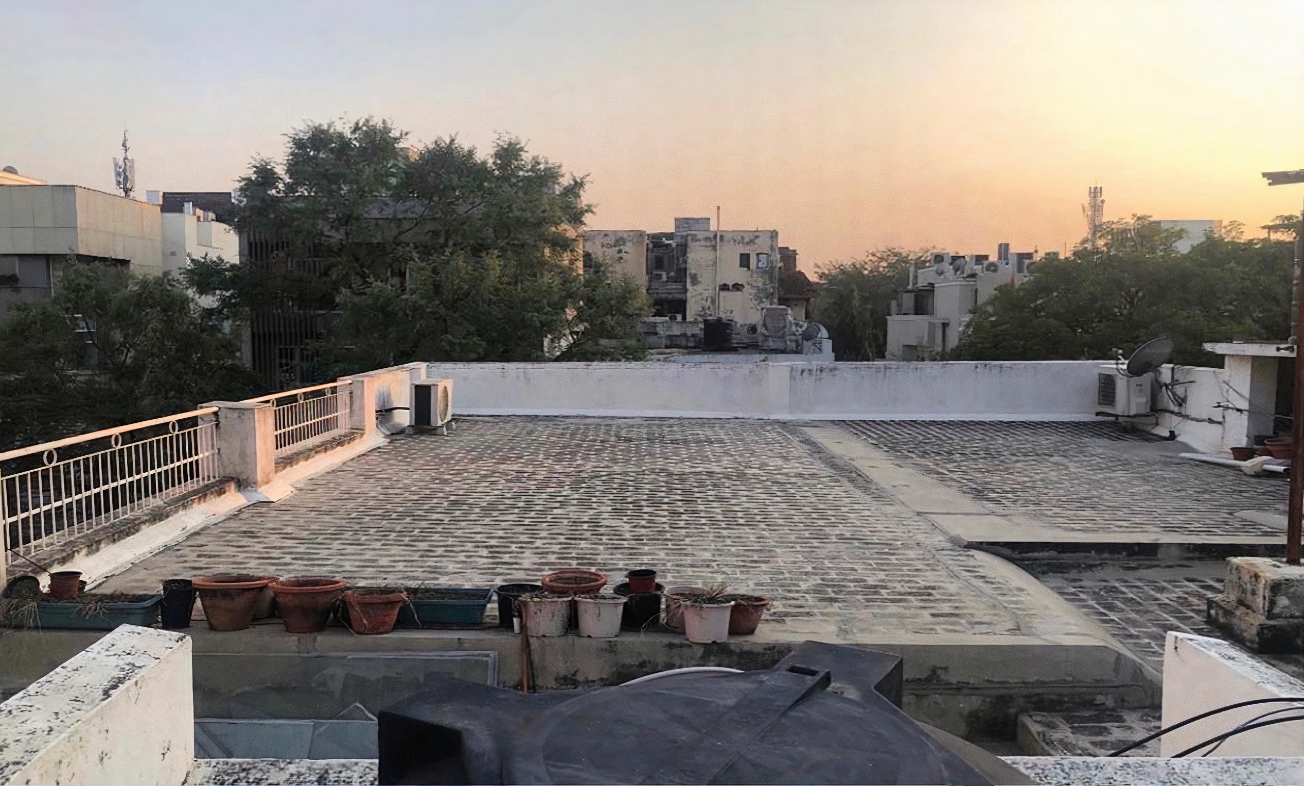 Aman's empty brick rooftop at dusk.