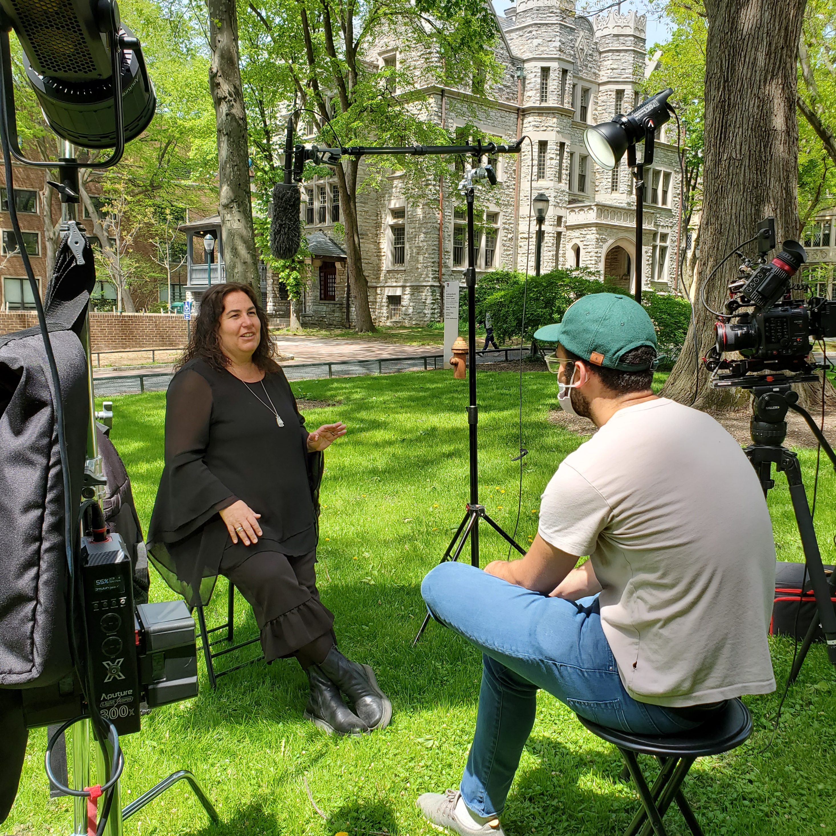 Karen Shaffran being interviewed and filmed by media crew on U Penn campus.