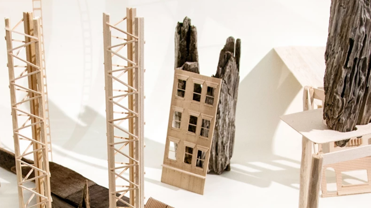 Eli Brown, Toxic Places. Wooden structures resembling houses and ladders lean on a white background