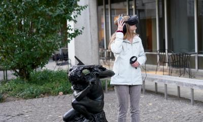 VR user with headset in front of the Van Pelt Library